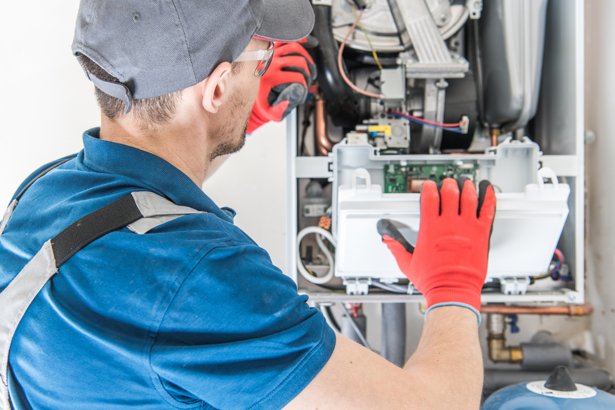 Technician Trying To Fix the Problem with the Residential Heating Equipment.